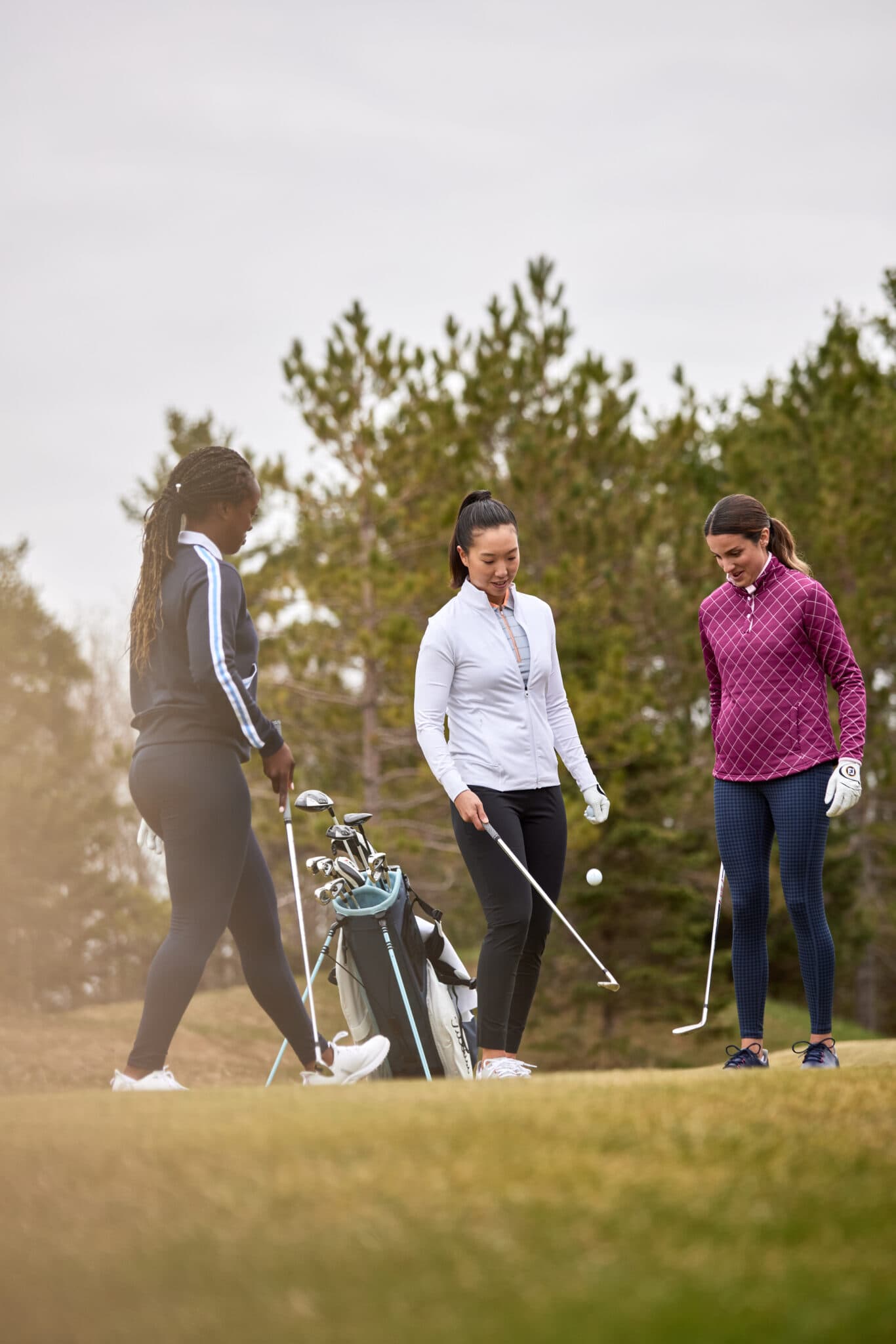 Three women casually warming up for a game of golf. Image taken by fitness lifestyle photographer Hannah Dunsirn, who is based in LA County.
