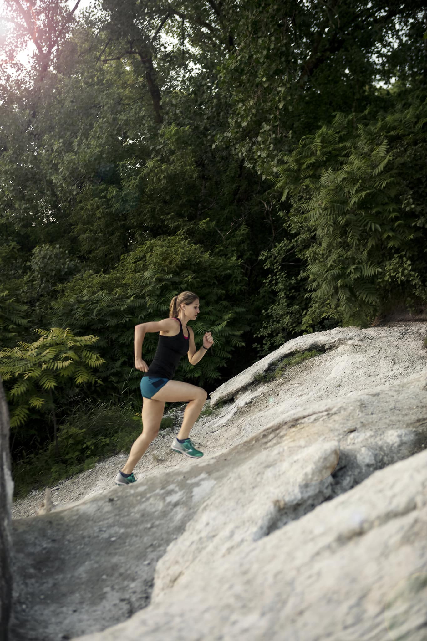 woman running up rocky terrain