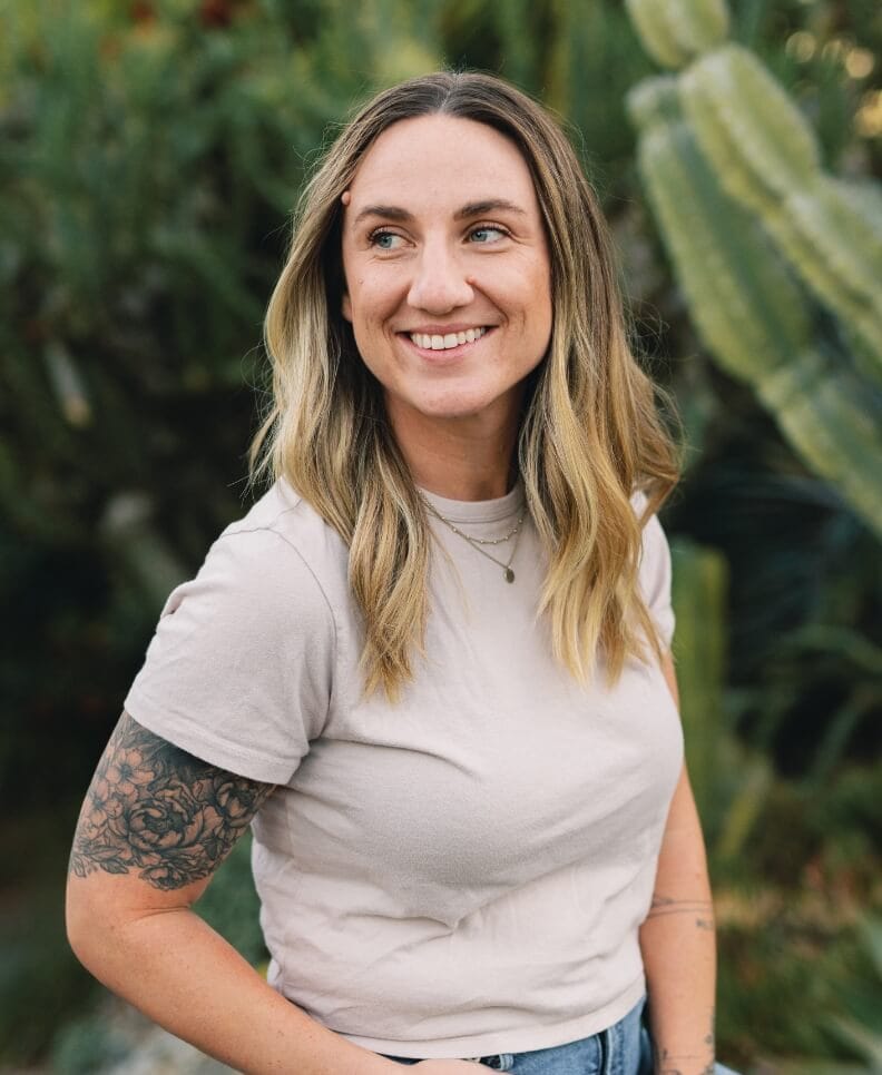 portrait of Hannah smiling in front of greenery